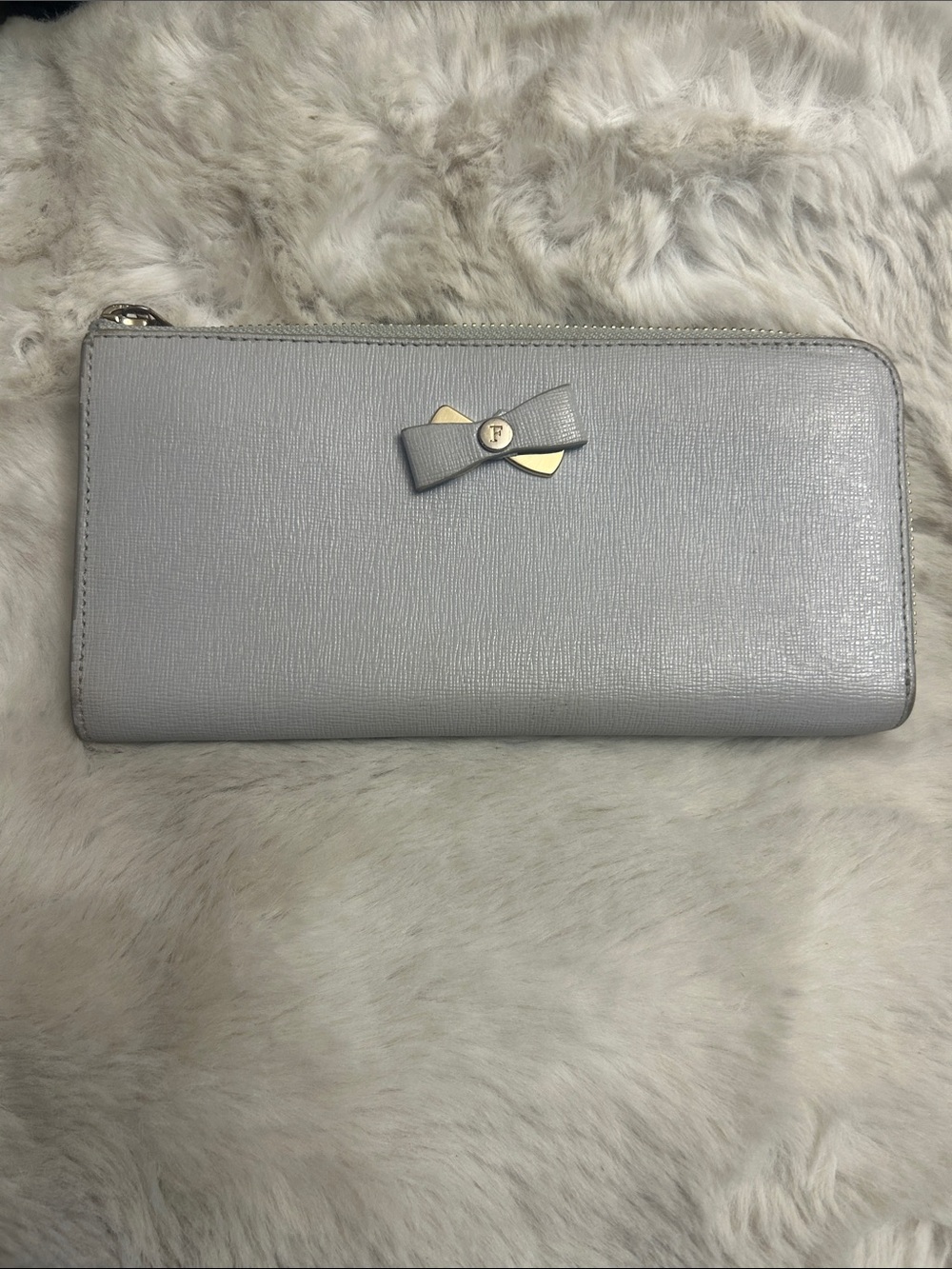 Furla light blue Saffiano leather half zip long wallet with bow